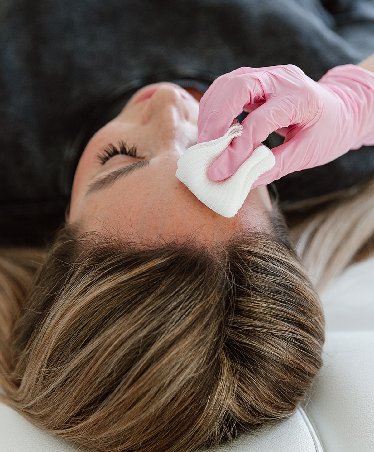 Skincare treatment with a cotton pad application.