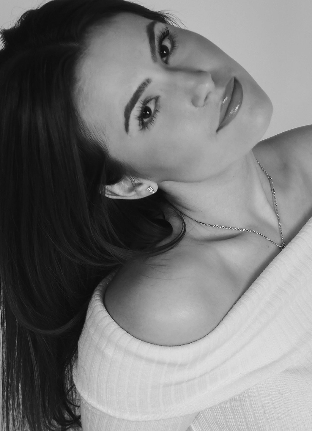 Portrait of a woman in off-shoulder top.